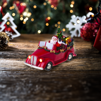 Santa en coche con árbol giratorio